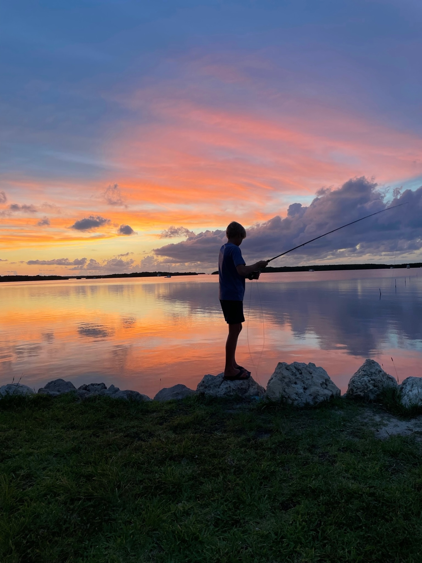 Fly angler casting on a Florida flat at sunset